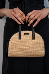 Sac Demi-Lune A.P.C. en raphia naturel beige et cuir noir, forme demi-lune, fermeture magnétique et quincaillerie dorée, fabrication marocaine_Vue de face