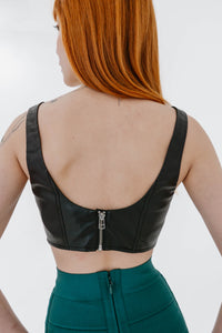 Top court Wells de Staud en faux cuir noir sans manches, style débardeur ajusté, silhouette moderne et minimaliste, finition mate = vue de dos